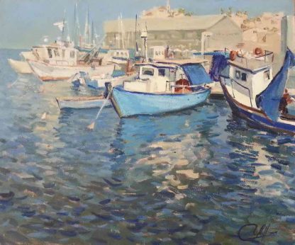 Small boats at Jaffa port floating on the bluish water